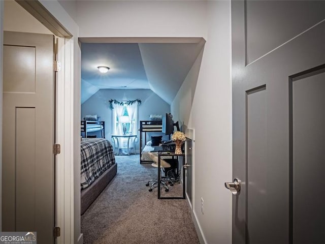 bedroom featuring vaulted ceiling and carpet floors