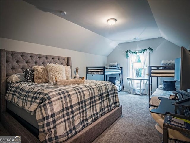 carpeted bedroom featuring lofted ceiling