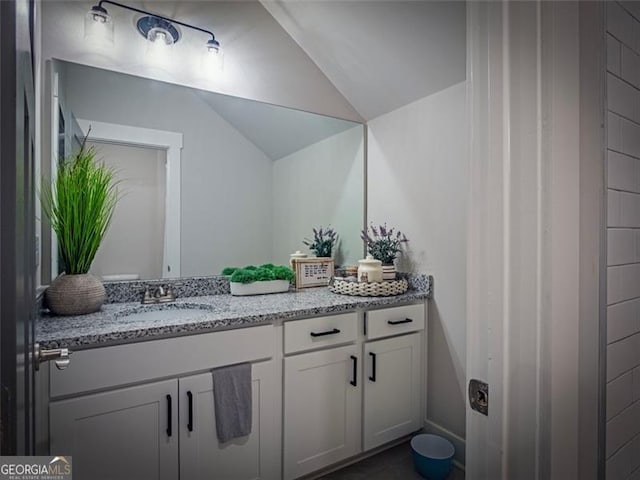 bathroom with vanity and vaulted ceiling