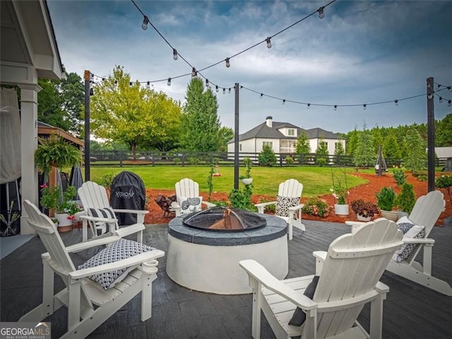 view of patio featuring a wooden deck and an outdoor fire pit