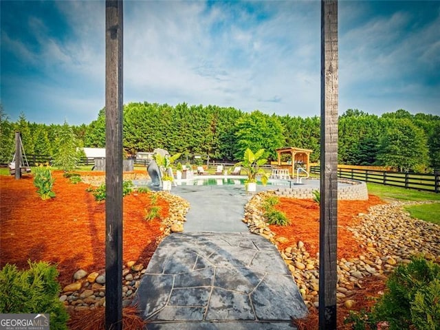 view of property's community featuring a gazebo, a pool, and a patio