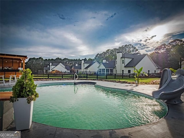 view of pool featuring a patio and a water slide