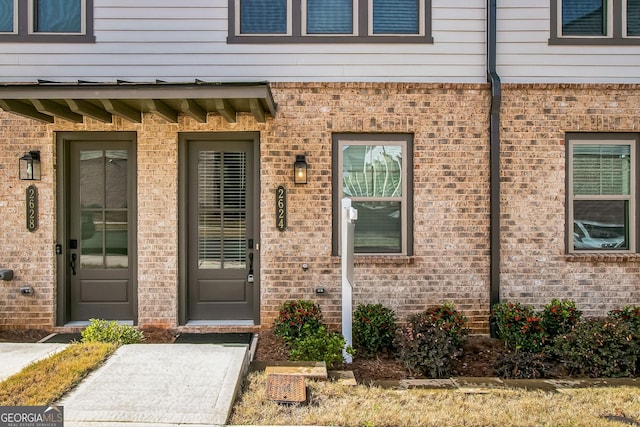 property entrance featuring brick siding