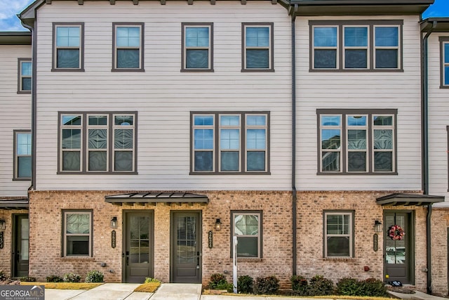 view of property with brick siding