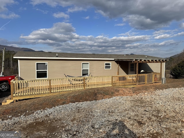 back of house featuring a deck