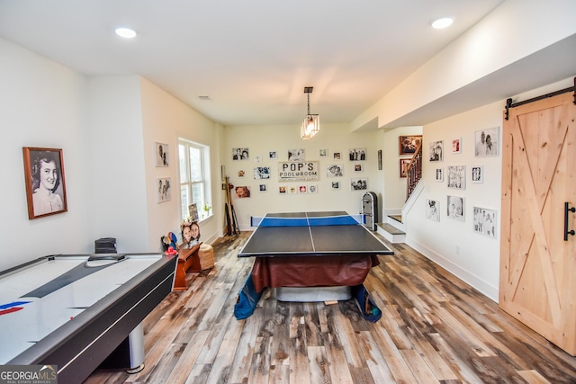 playroom featuring wood-type flooring and a barn door