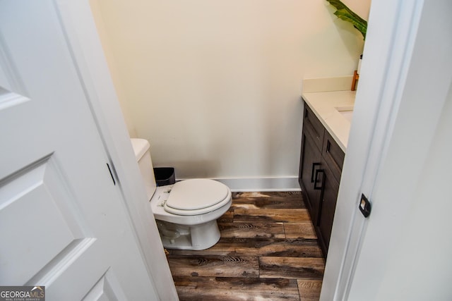 bathroom with vanity, hardwood / wood-style floors, and toilet