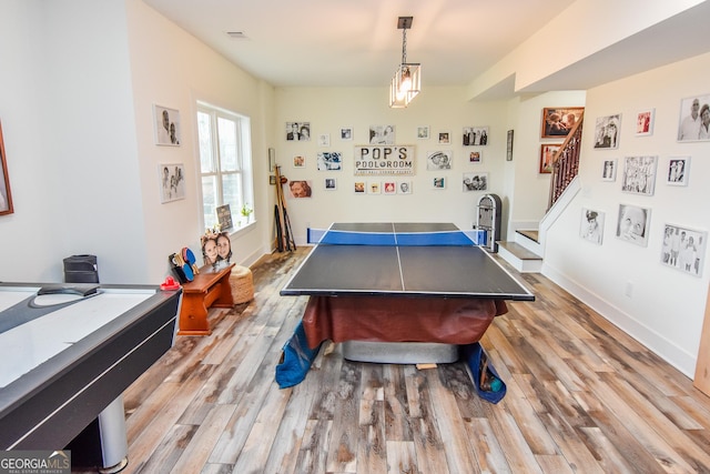 game room with light wood-type flooring