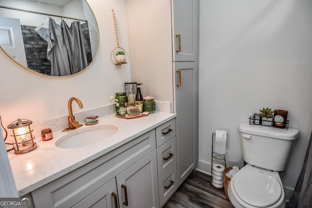 bathroom featuring hardwood / wood-style flooring, vanity, toilet, and a shower with curtain