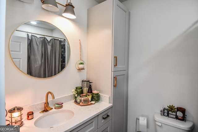 bathroom with vanity, walk in shower, and toilet