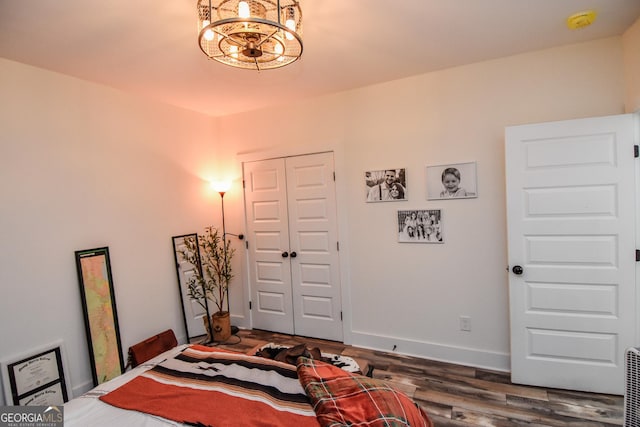 bedroom with dark hardwood / wood-style flooring and a closet