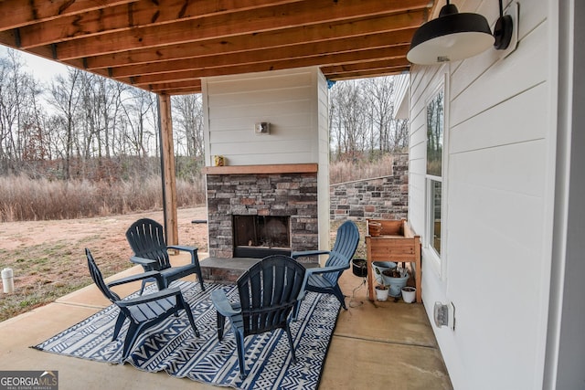 view of patio featuring an outdoor stone fireplace