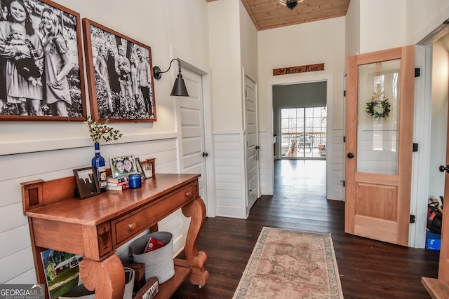 entryway featuring dark hardwood / wood-style flooring and wooden ceiling