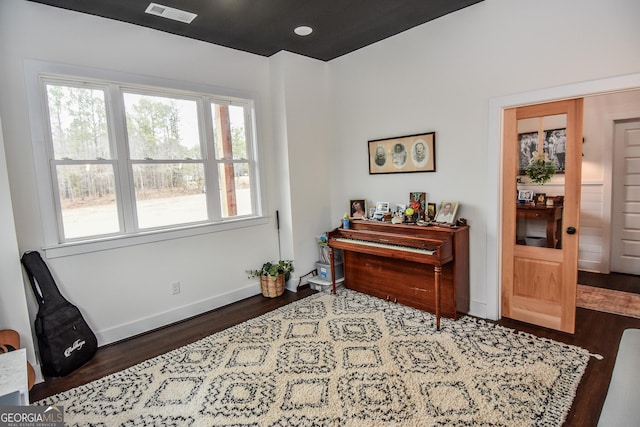 miscellaneous room featuring dark wood-type flooring