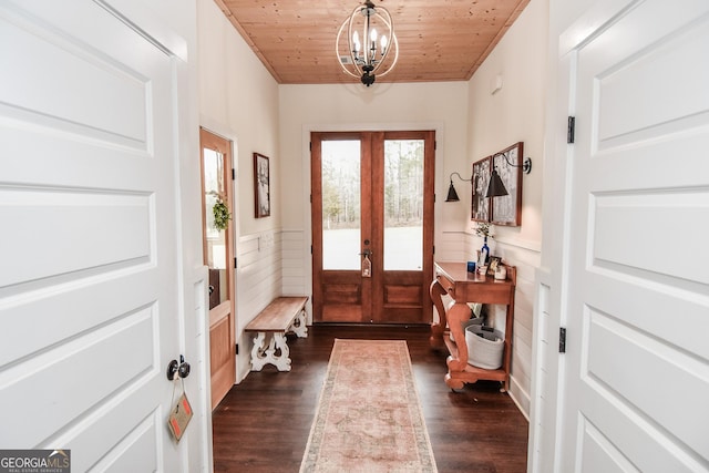 doorway to outside featuring french doors, dark hardwood / wood-style floors, a chandelier, and wooden ceiling