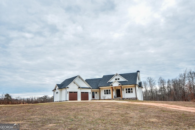 view of front facade with a garage and a front lawn