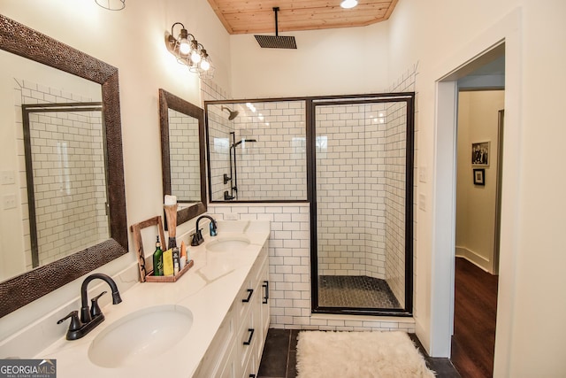 bathroom featuring vanity, a shower with shower door, and wooden ceiling