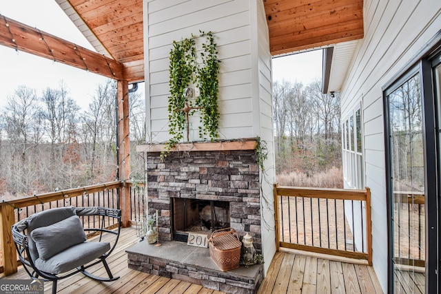 deck featuring an outdoor stone fireplace