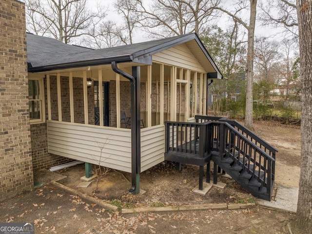 view of property exterior featuring a sunroom