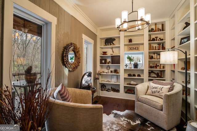 185 Huckleberry Cove Rd, Jasper, GA 30143 - living area featuring a chandelier, wood finished floors, built in shelves, and ornamental molding