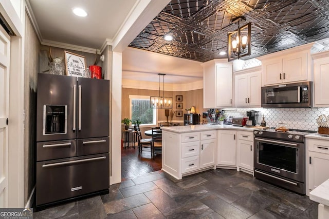 185 Huckleberry Cove Rd, Jasper, GA 30143 - kitchen featuring high end appliances, a chandelier, a peninsula, light countertops, and backsplash