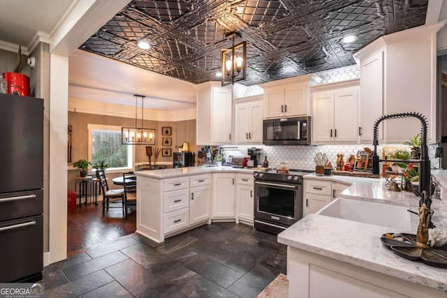 185 Huckleberry Cove Rd, Jasper, GA 30143 - kitchen with stainless steel appliances, an ornate ceiling, a peninsula, decorative backsplash, and a chandelier