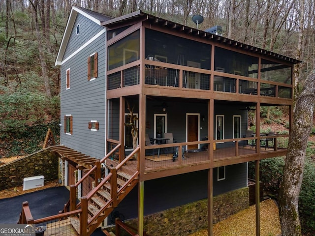 185 Huckleberry Cove Rd, Jasper, GA 30143 - rear view of property featuring a sunroom, a deck, a wooded view, and stairs