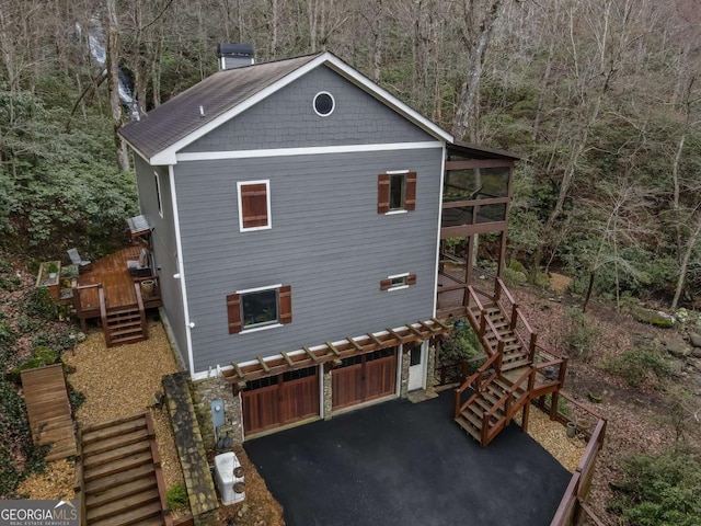185 Huckleberry Cove Rd, Jasper, GA 30143 - view of side of property with stairs, an attached garage, driveway, a deck, and a view of trees