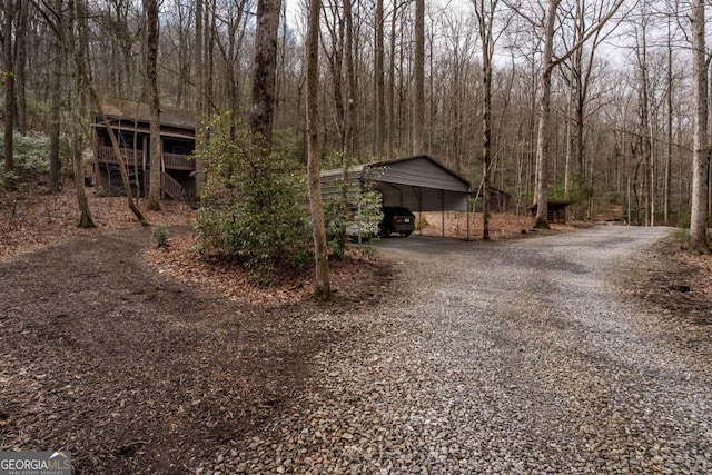 185 Huckleberry Cove Rd, Jasper, GA 30143 - exterior space featuring a detached carport, gravel driveway, and a wooded view