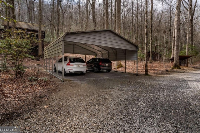 185 Huckleberry Cove Rd, Jasper, GA 30143 - view of parking / parking lot featuring a detached carport, gravel driveway, and a wooded view