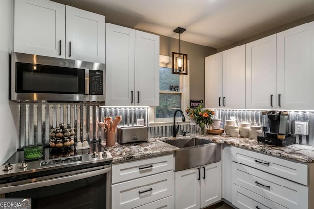 185 Huckleberry Cove Rd, Jasper, GA 30143 - kitchen with stainless steel appliances, white cabinetry, light stone counters, and hanging light fixtures