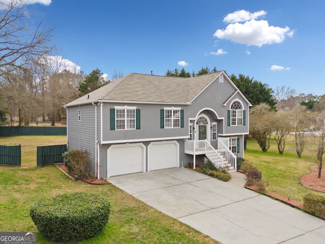 split foyer home featuring a garage and a front yard