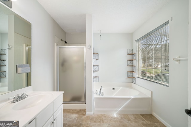 bathroom with vanity, tile patterned flooring, plus walk in shower, and a textured ceiling