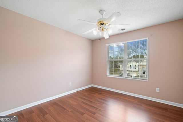 unfurnished room with ceiling fan, dark hardwood / wood-style floors, and a textured ceiling