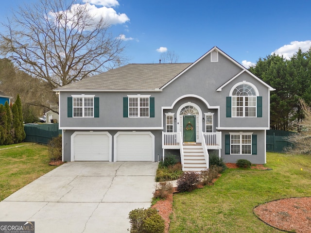 split foyer home featuring a garage and a front yard