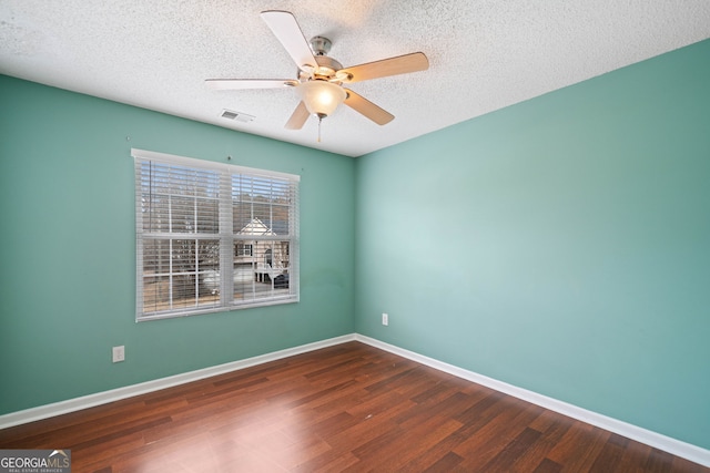 unfurnished room with ceiling fan, dark hardwood / wood-style floors, and a textured ceiling