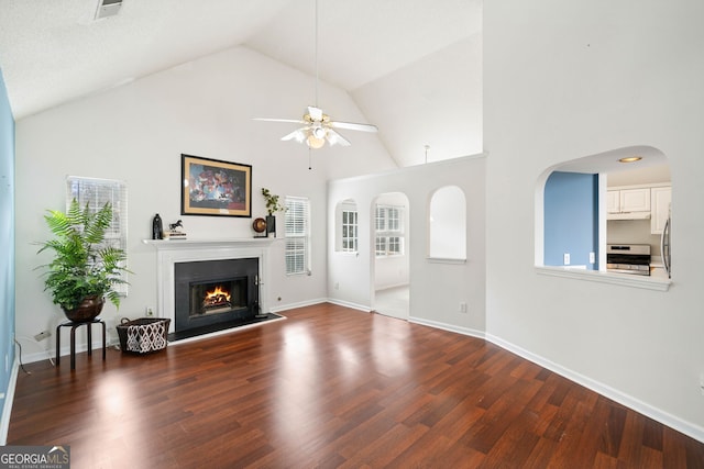 unfurnished living room featuring ceiling fan, high vaulted ceiling, and dark hardwood / wood-style flooring