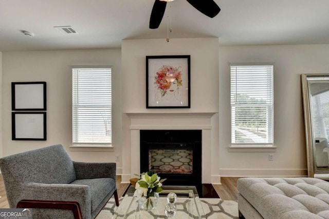 living room with ceiling fan and light wood-type flooring