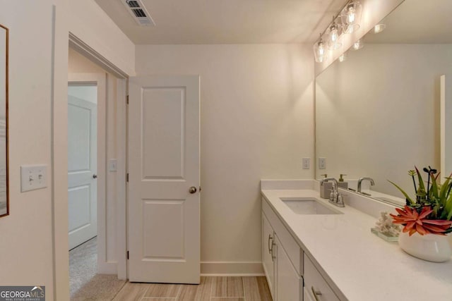 bathroom with vanity and hardwood / wood-style floors