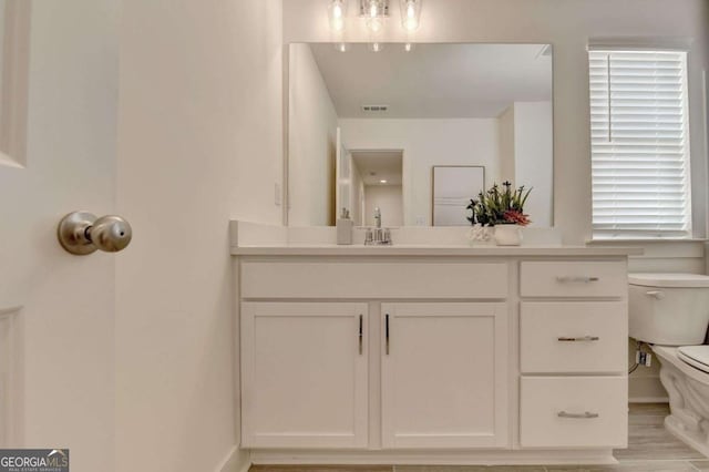 bathroom with vanity and toilet