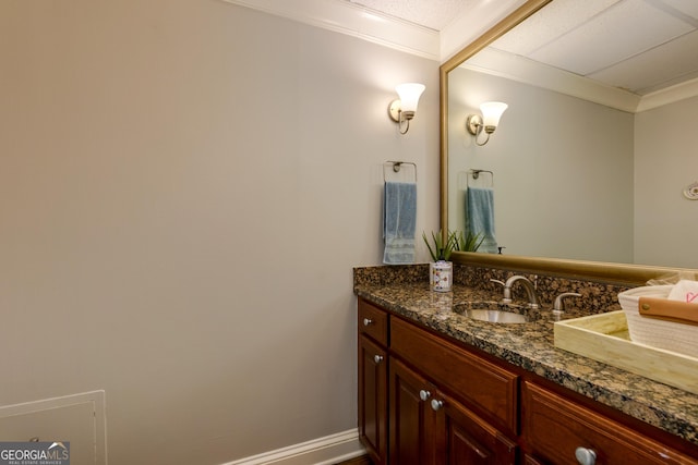 bathroom featuring vanity, baseboards, and ornamental molding