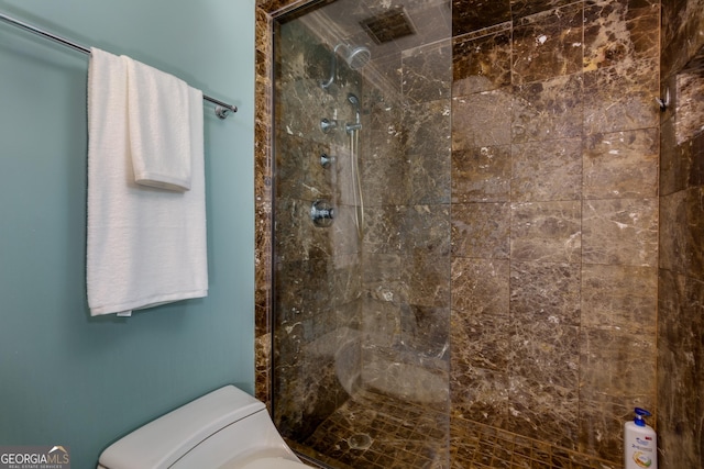 full bathroom featuring toilet and a tile shower