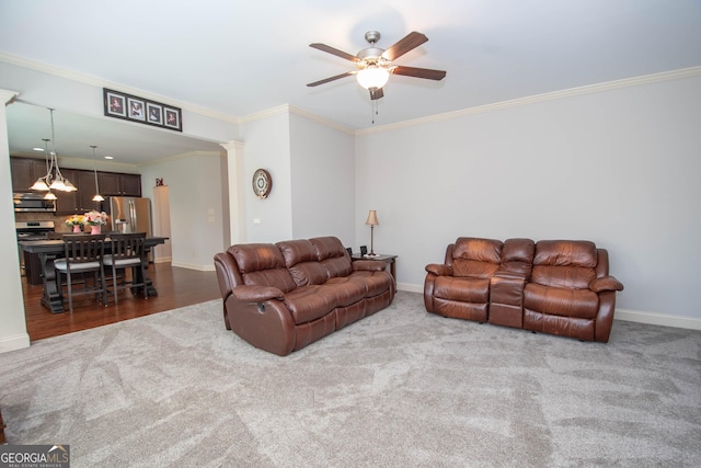 living room with baseboards, crown molding, and ornate columns