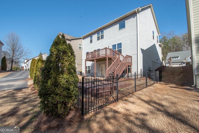 view of front facade with stairway, fence, and a deck