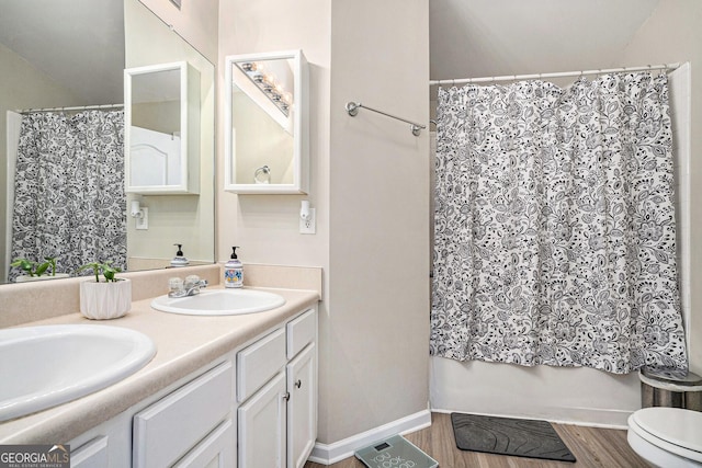 full bathroom featuring wood-type flooring, vanity, shower / bathtub combination with curtain, and toilet