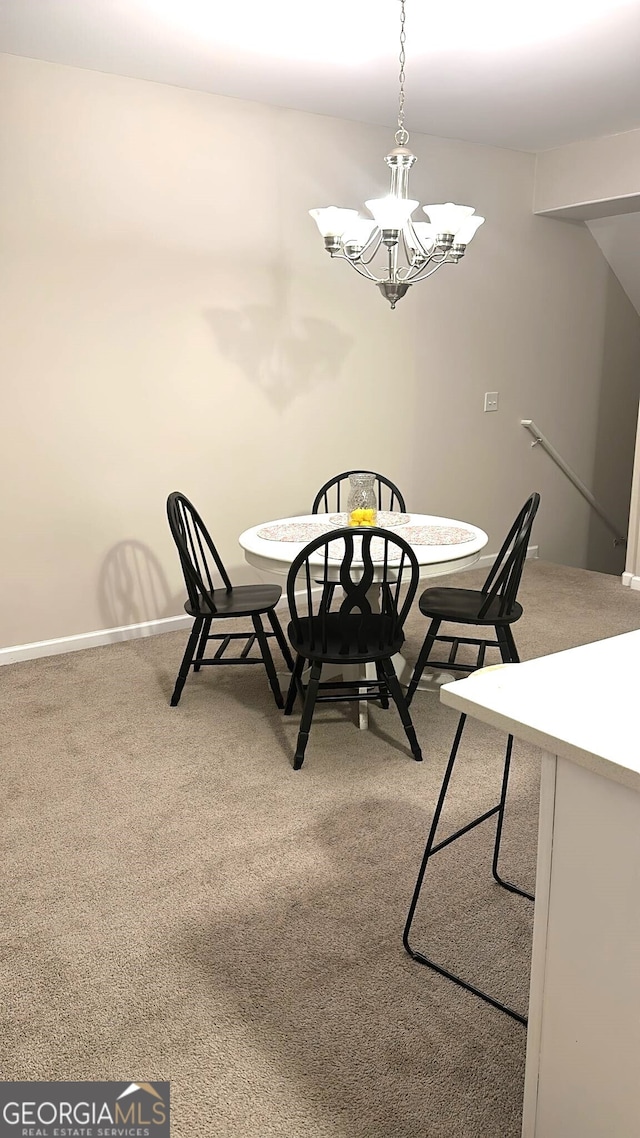 dining room with a chandelier and carpet floors