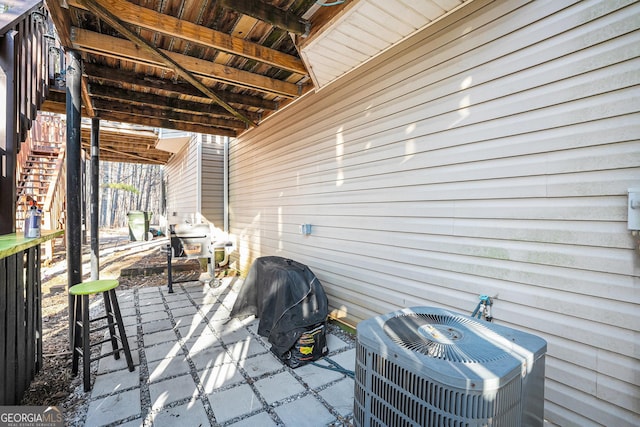 view of patio / terrace featuring grilling area and central air condition unit