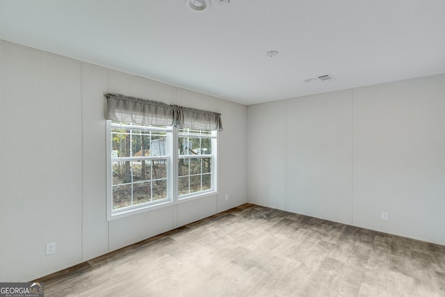 spare room featuring wood finished floors