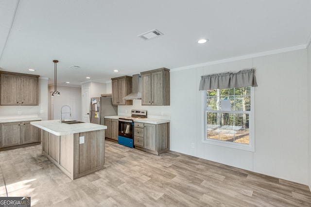 kitchen featuring range with electric stovetop, a sink, visible vents, freestanding refrigerator, and wall chimney exhaust hood