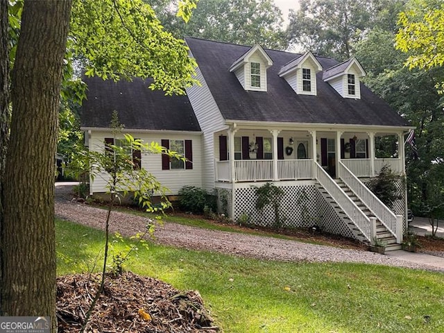 cape cod house featuring covered porch and a front yard